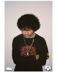 a man wearing a black shirt with a heart on it
