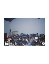 a crowd of people standing in a room