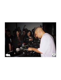 a man djing in front of a crowd of people