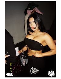 a woman in a black outfit posing for a picture